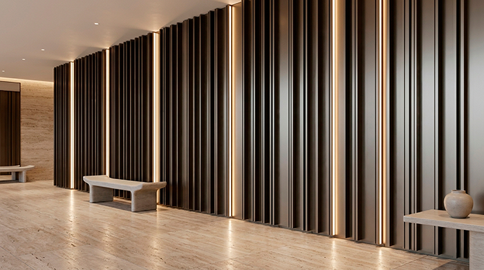Pasillo interior de diseño revestido con lamas verticales de aluminio oscuro de la Serie E-170, intercaladas con tiras de iluminación LED cálida.