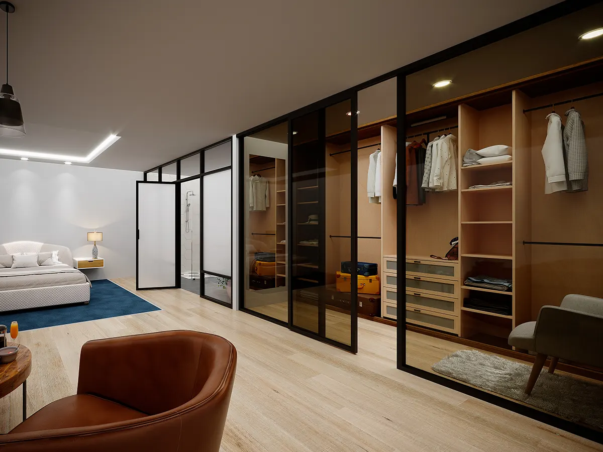 Mampara divisoria interior de aluminio negro con diseño de cuadrícula y una puerta abatible abierta que da acceso a un vestidor iluminado.